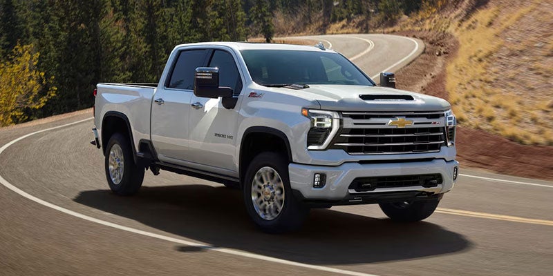 A white Chevrolet Silverado 3500HD driving on road